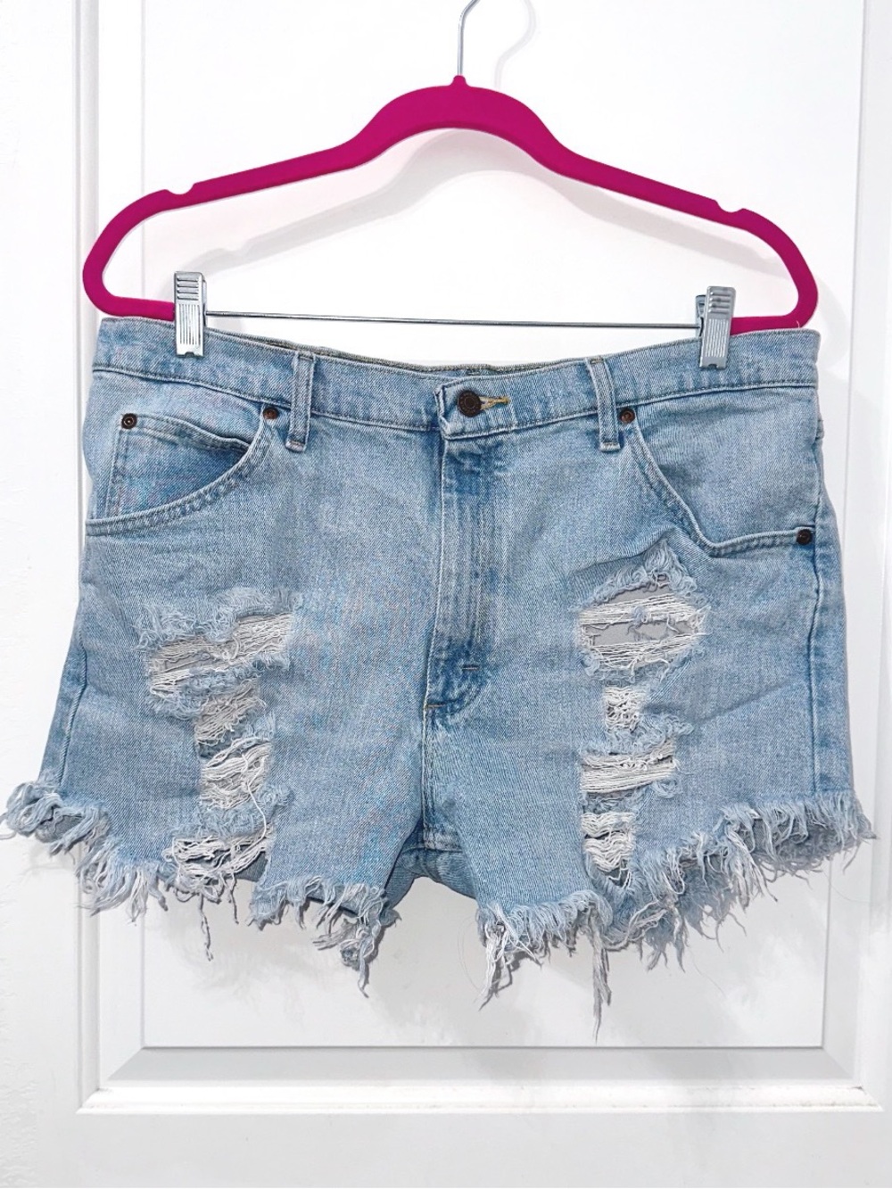 Wrangler light-wash distressed denim cut-off shorts featuring heavy-rippin